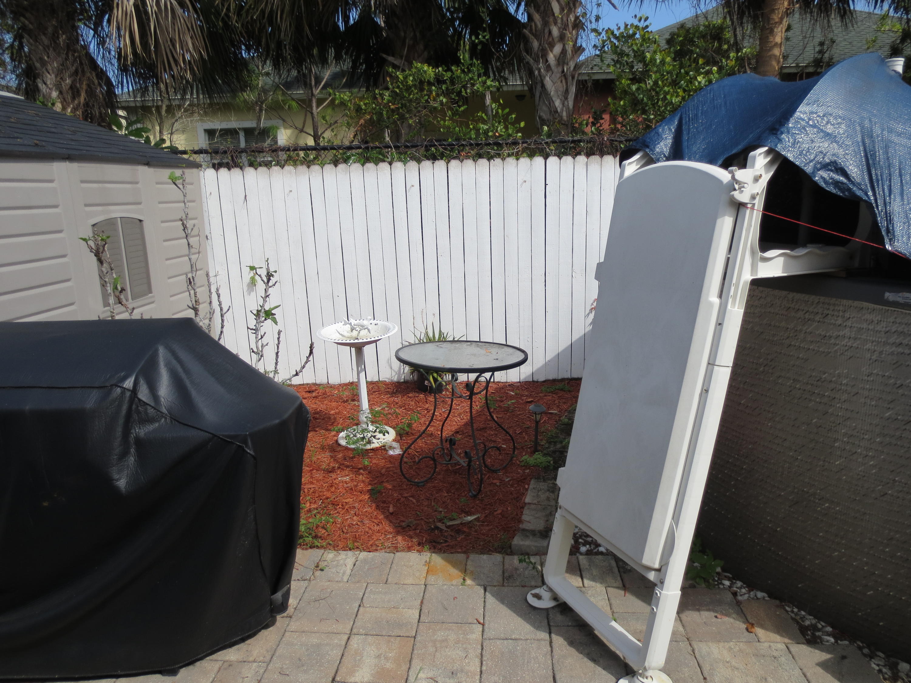 3768 Mil-Stream Court Greenacres, FL 33463 - Photo 24 of 36 a view of a chairs and table in backyard