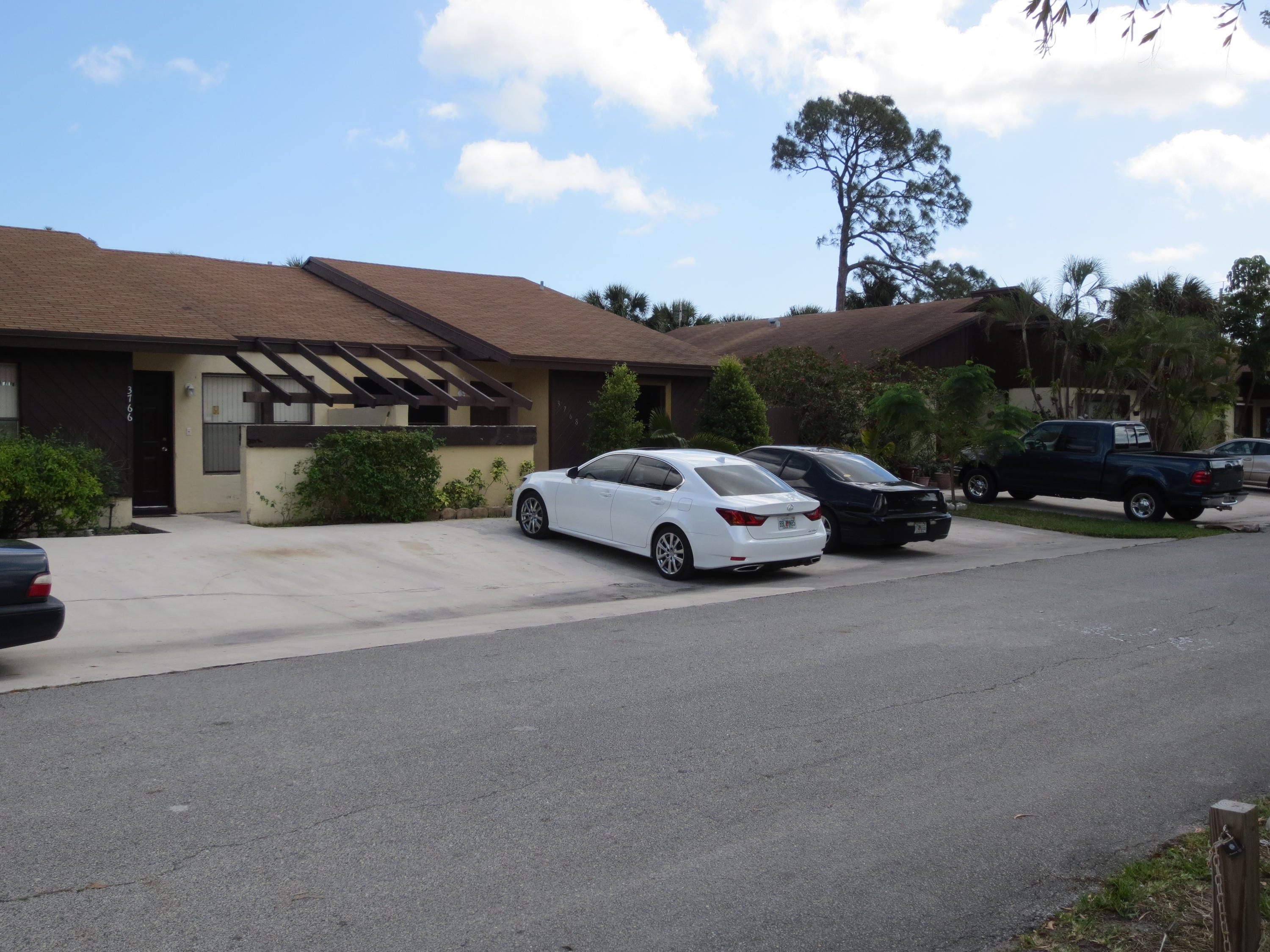 3768 Mil-Stream Court Greenacres, FL 33463 - Photo 27 of 36 a car parked on the side of the road