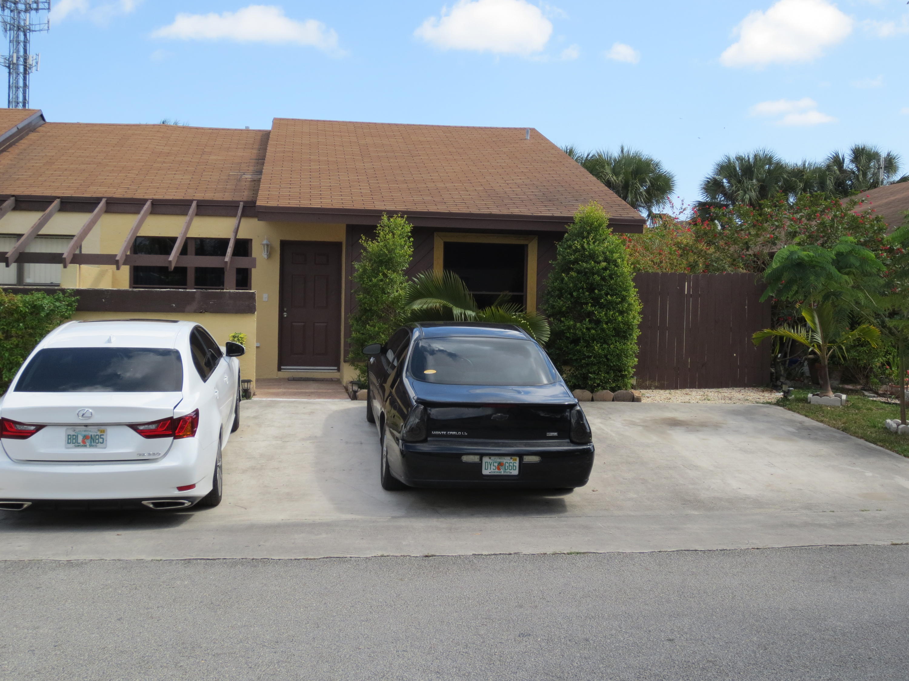3768 Mil-Stream Court Greenacres, FL 33463 - Photo 28 of 36 a car parked in front of a house