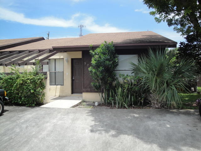3768 Mil-Stream Court Greenacres, FL 33463 - Photo 29 of 36 a view of a house with plants and a lawn chairs