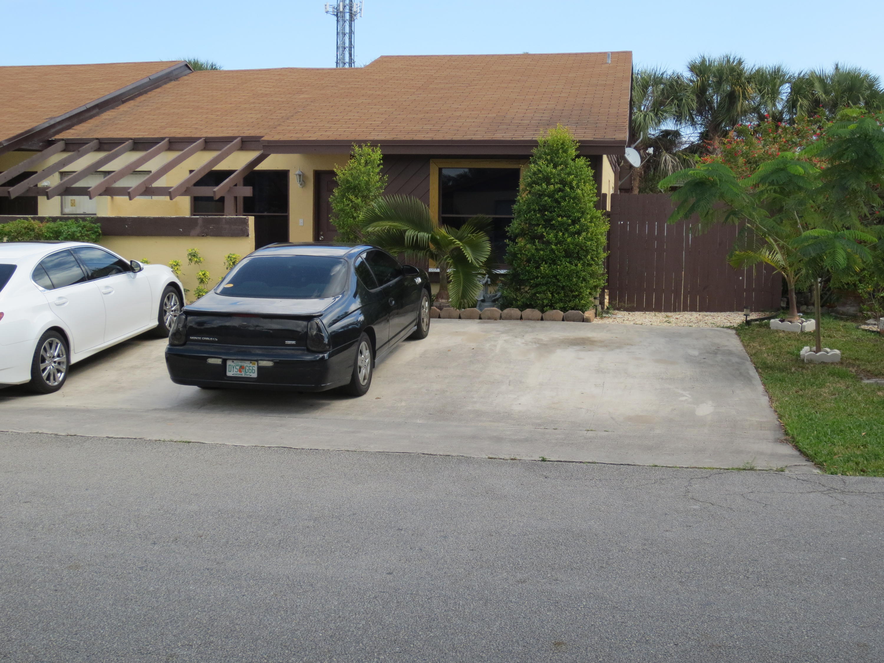 3768 Mil-Stream Court Greenacres, FL 33463 - Photo 30 of 36 a car parked in front of a house