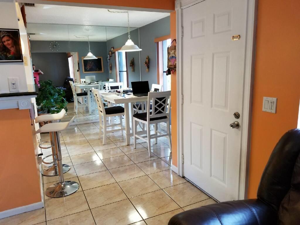 3768 Mil-Stream Court Greenacres, FL 33463 - Photo 3 of 36 a view of a dining room with furniture and wooden floor