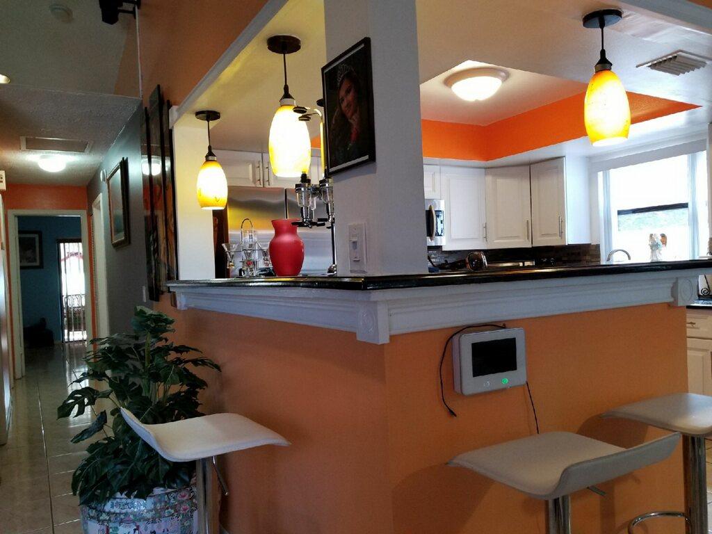 3768 Mil-Stream Court Greenacres, FL 33463 - Photo 4 of 36 a kitchen with stainless steel appliances kitchen island a table and chairs in it