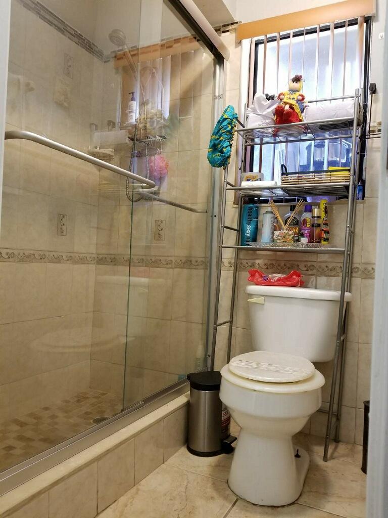 3768 Mil-Stream Court Greenacres, FL 33463 - Photo 7 of 36 a bathroom with a toilet and a shower