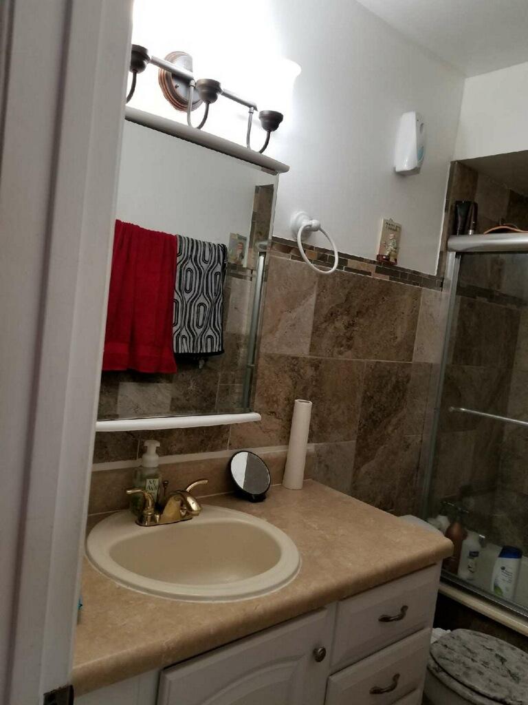 3768 Mil-Stream Court Greenacres, FL 33463 - Photo 10 of 36 a bathroom with a sink and a mirror