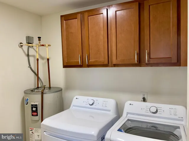 a bathroom with a sink a stove and cabinets