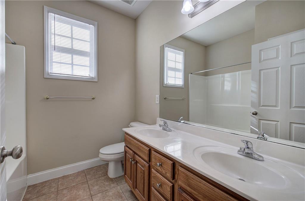 29 Autumn Street Northwest Cartersville, GA 30121 - Photo 26 of 31 a bathroom with a granite countertop sink a toilet and a mirror