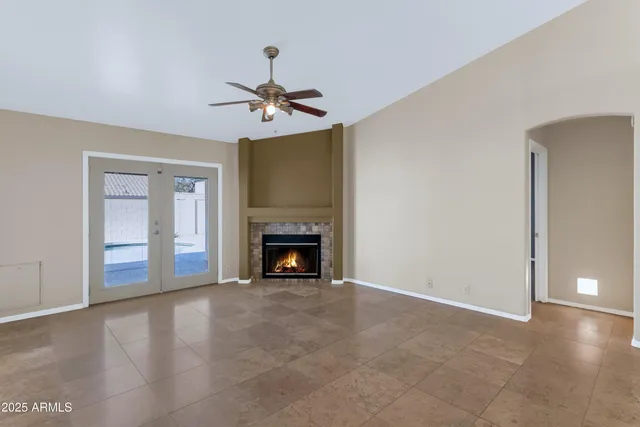a view of an empty room with a fireplace and a window