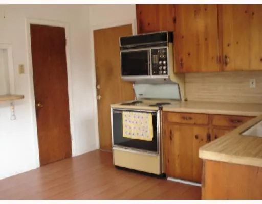 a kitchen with a stove and a microwave