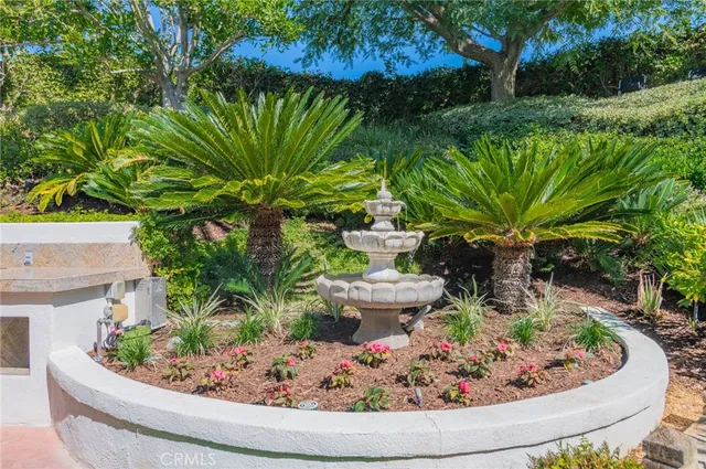 a view of a patio with table and chairs potted plants and large tree