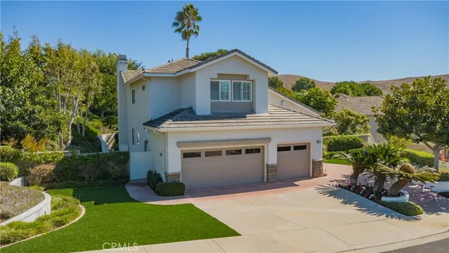 a view of a house with a yard and sitting area