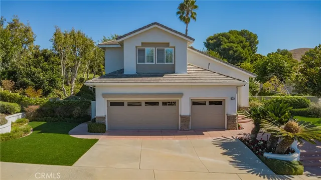 a front view of house with a garden