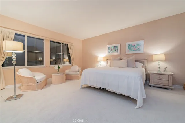 a living room with stainless steel appliances granite countertop furniture a fireplace a flat screen tv and a window