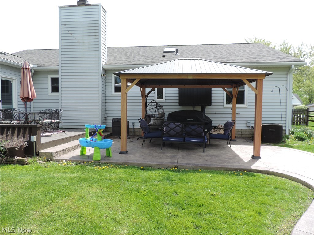 24770 Maple Ridge Road Westlake, OH 44145 - Photo 25 of 26 Rear view of property featuring a deck, a gazebo, an outdoor hangout area, and a lawn