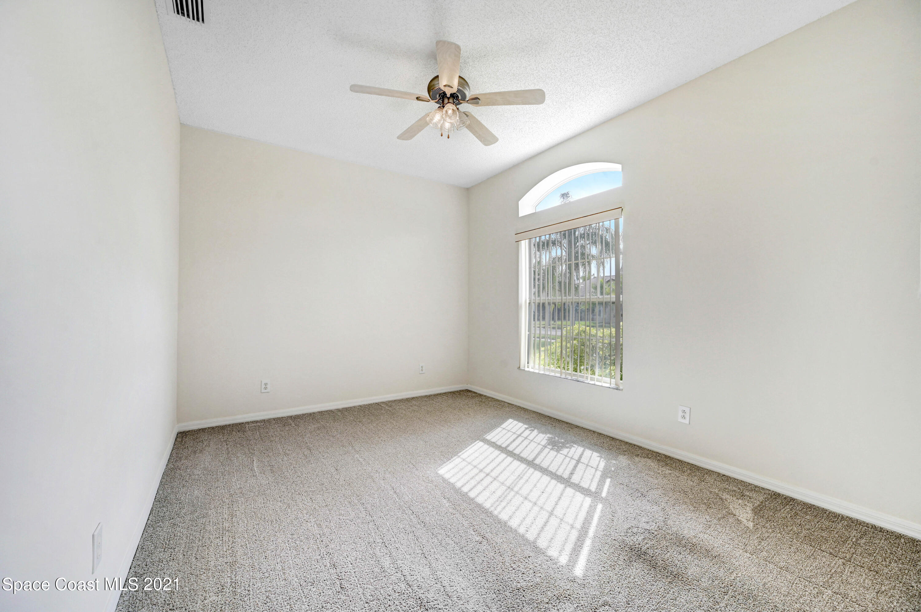 1475 Knoll Ridge Drive Melbourne, FL 32940 - Photo 11 of 39 an empty room with windows and fan