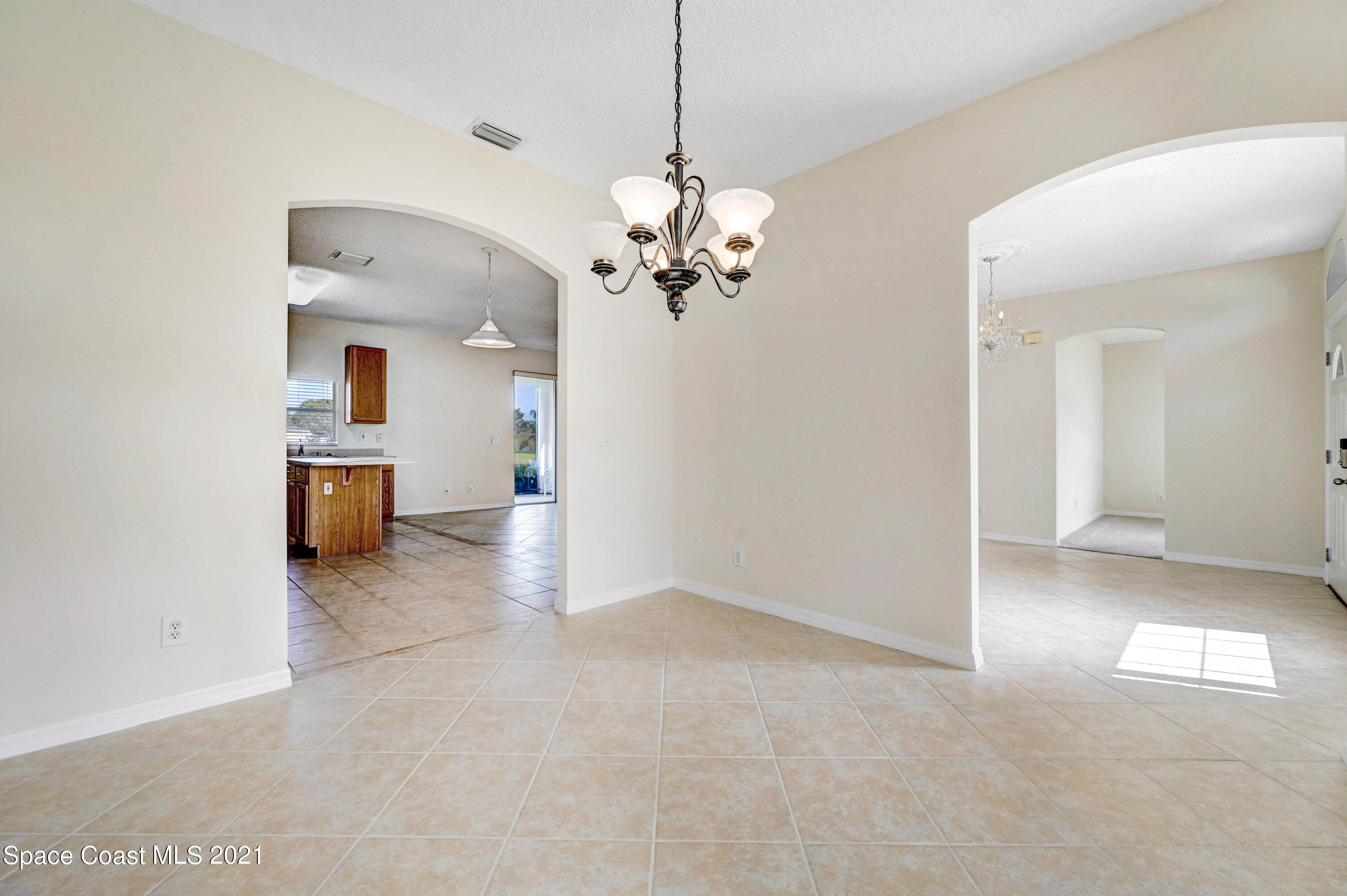 1475 Knoll Ridge Drive Melbourne, FL 32940 - Photo 13 of 39 a view of a house with a windows and a chandelier
