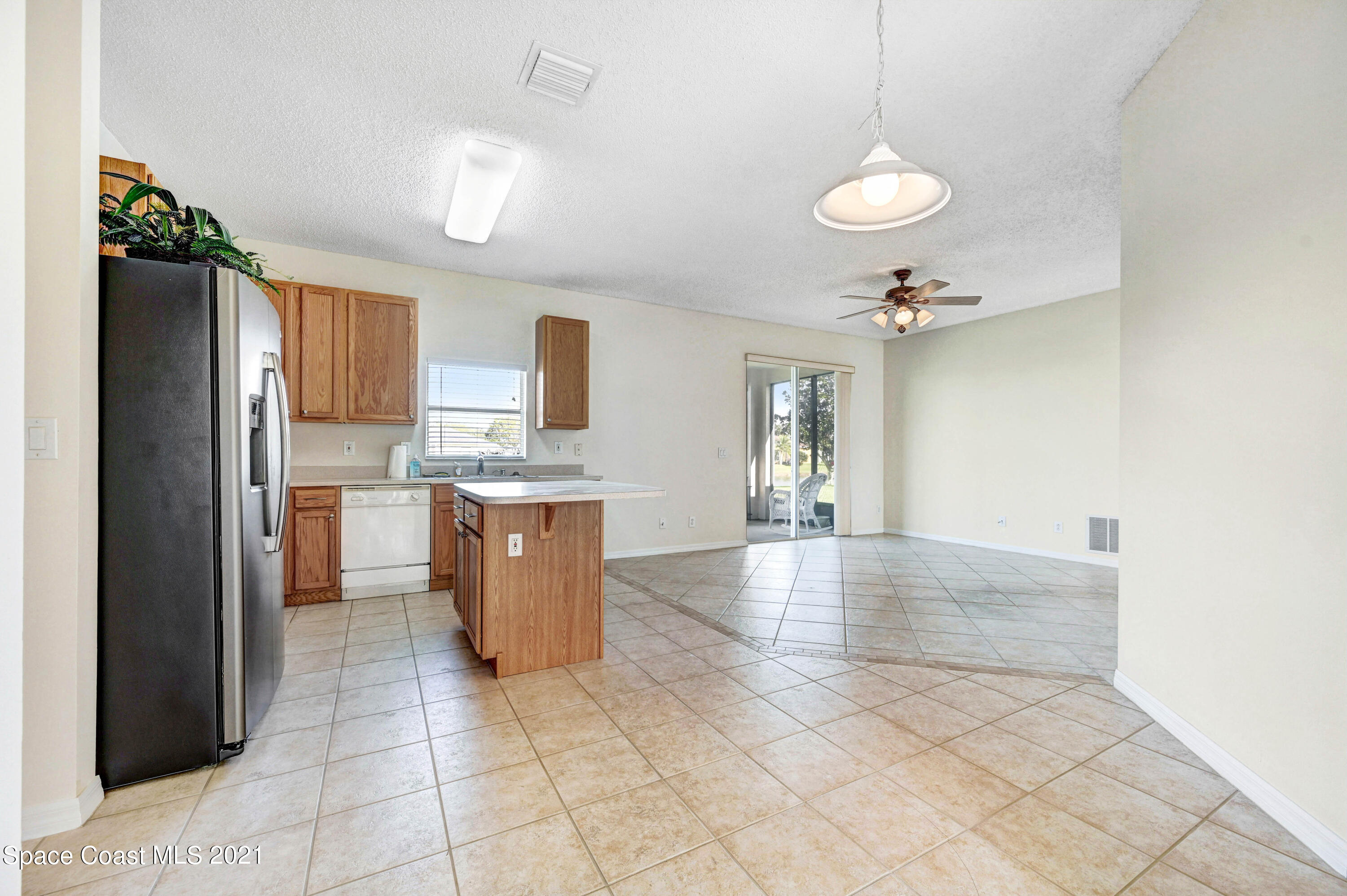 1475 Knoll Ridge Drive Melbourne, FL 32940 - Photo 14 of 39 a large kitchen with cabinets in it and wooden floor