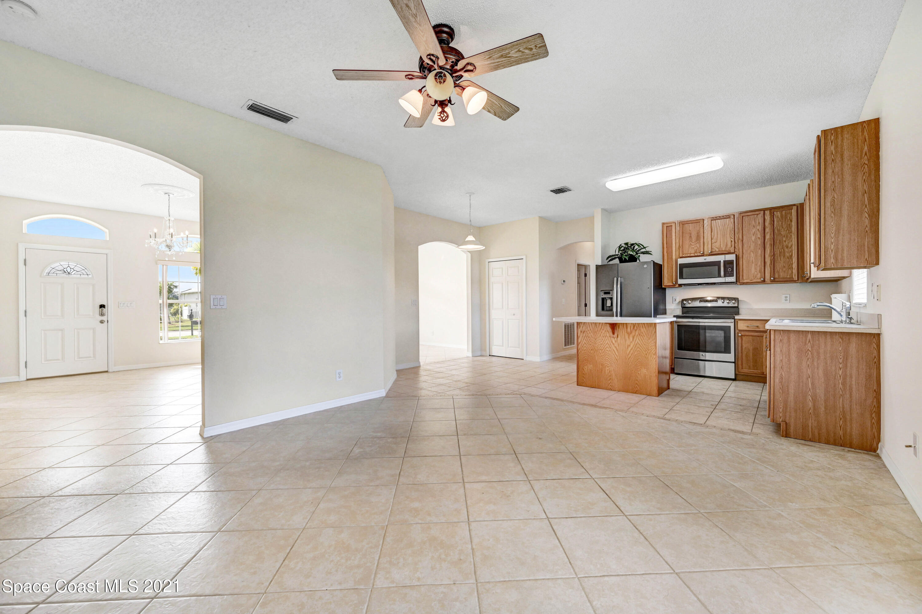 1475 Knoll Ridge Drive Melbourne, FL 32940 - Photo 15 of 39 a view of a kitchen with a sink and a microwave