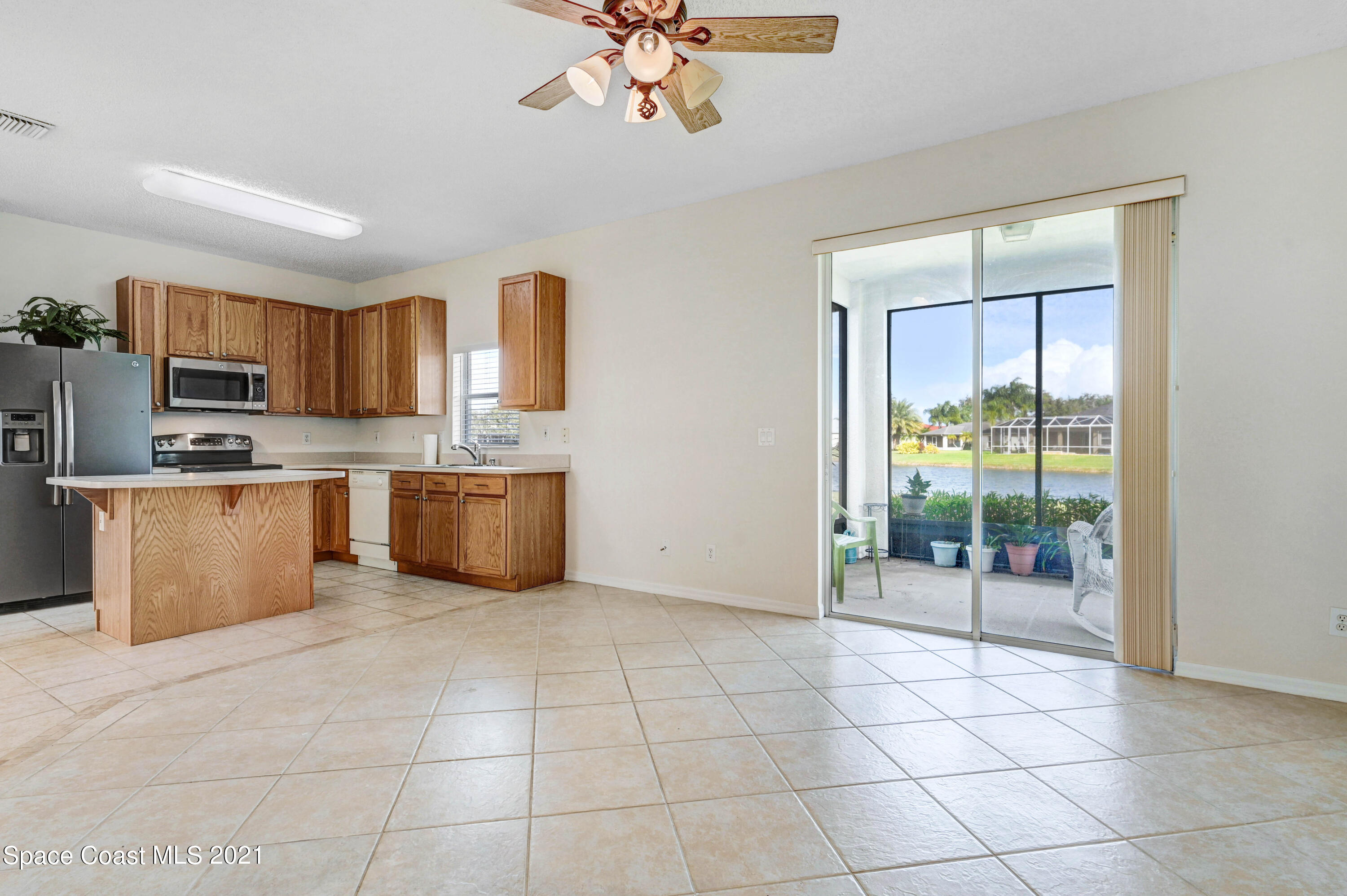 1475 Knoll Ridge Drive Melbourne, FL 32940 - Photo 16 of 39 a kitchen with stainless steel appliances granite countertop a stove a sink a microwave a counter top and cabinets