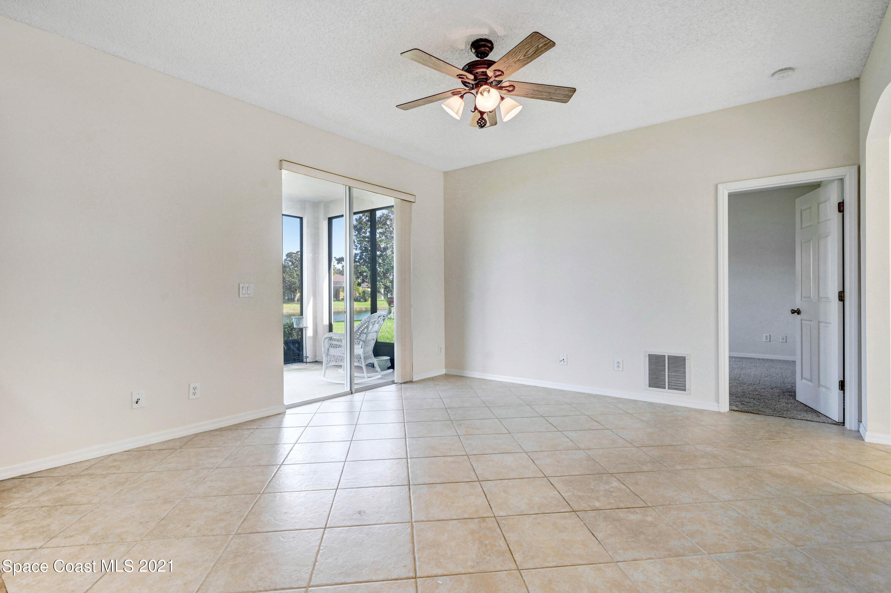 1475 Knoll Ridge Drive Melbourne, FL 32940 - Photo 20 of 39 a view of an empty room with a chandelier fan