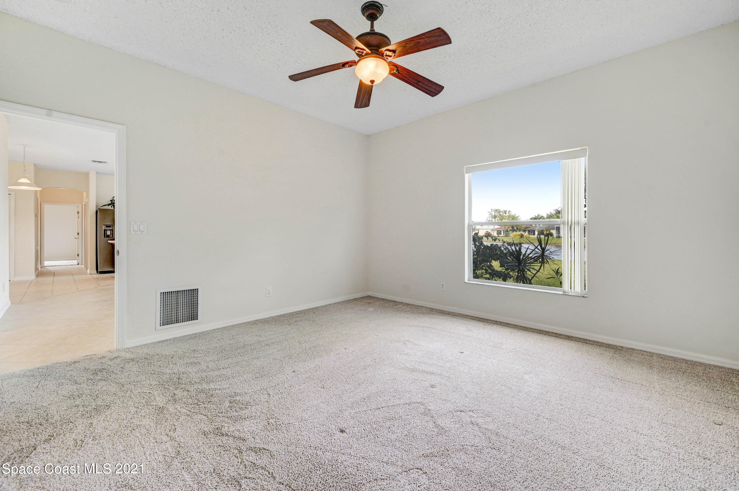 1475 Knoll Ridge Drive Melbourne, FL 32940 - Photo 23 of 39 an empty room with windows and fan