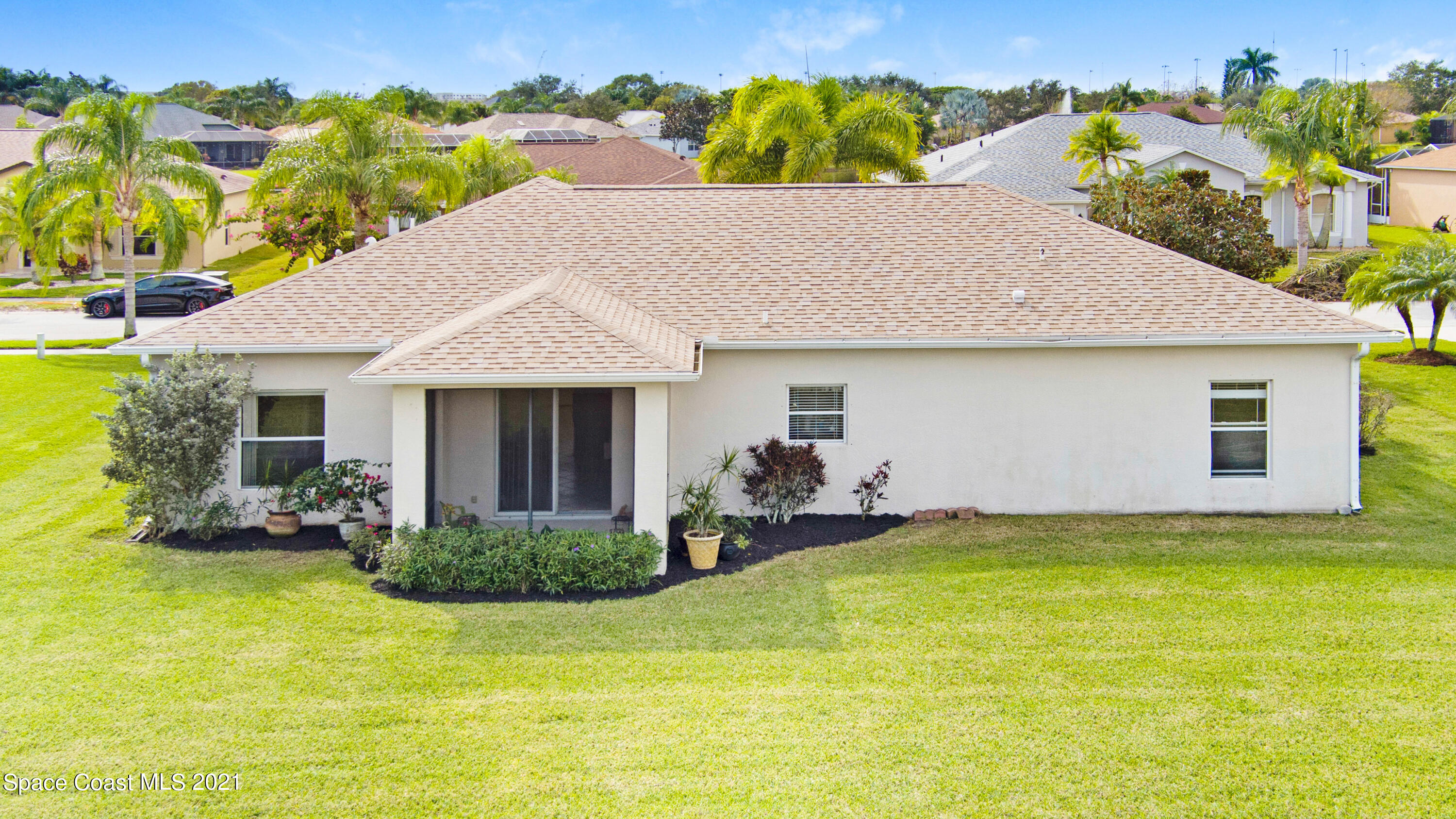 1475 Knoll Ridge Drive Melbourne, FL 32940 - Photo 35 of 39 a front view of a house with a garden and yard