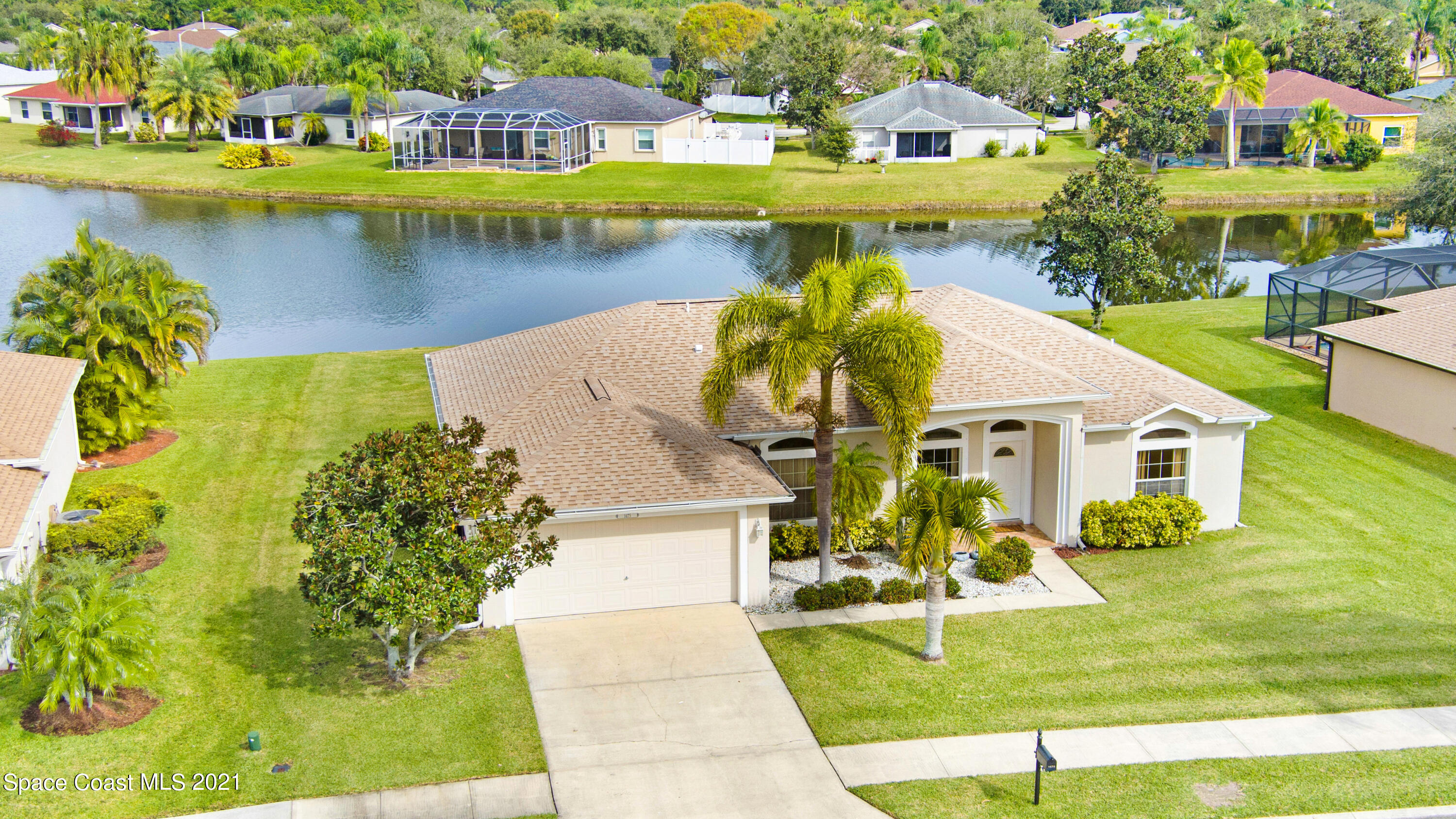 1475 Knoll Ridge Drive Melbourne, FL 32940 - Photo 5 of 39 a view of a swimming pool with a patio and a yard