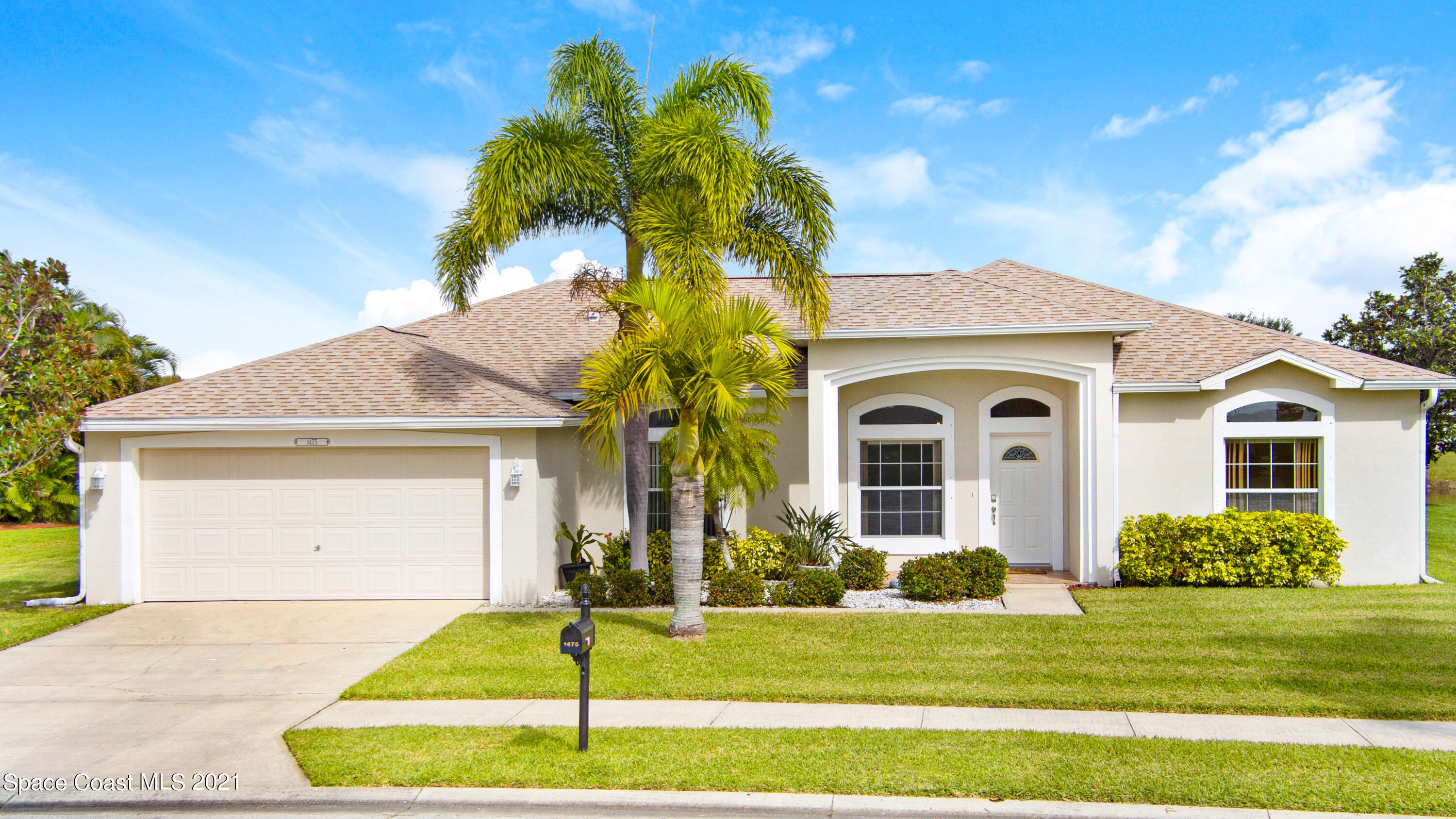 1475 Knoll Ridge Drive Melbourne, FL 32940 - Photo 7 of 39 a front view of a house with a yard
