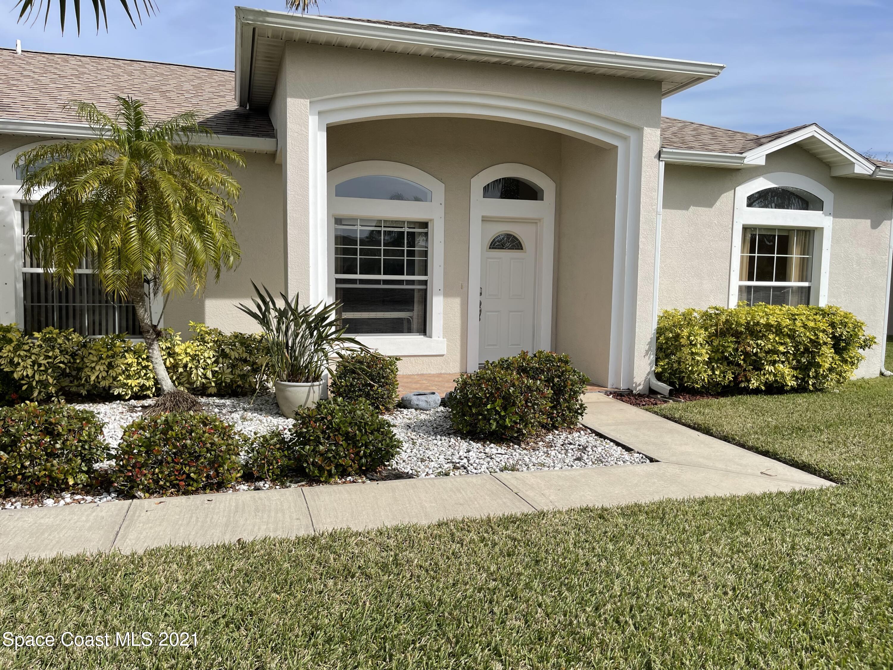 1475 Knoll Ridge Drive Melbourne, FL 32940 - Photo 8 of 39 a front view of a house with a yard