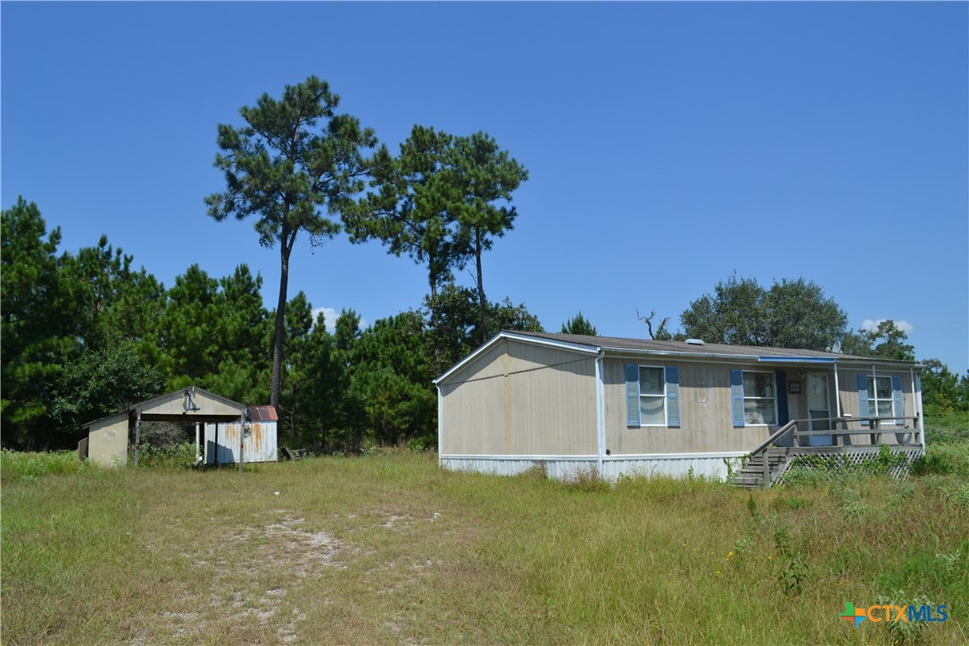 a yellow house with trees in front of it