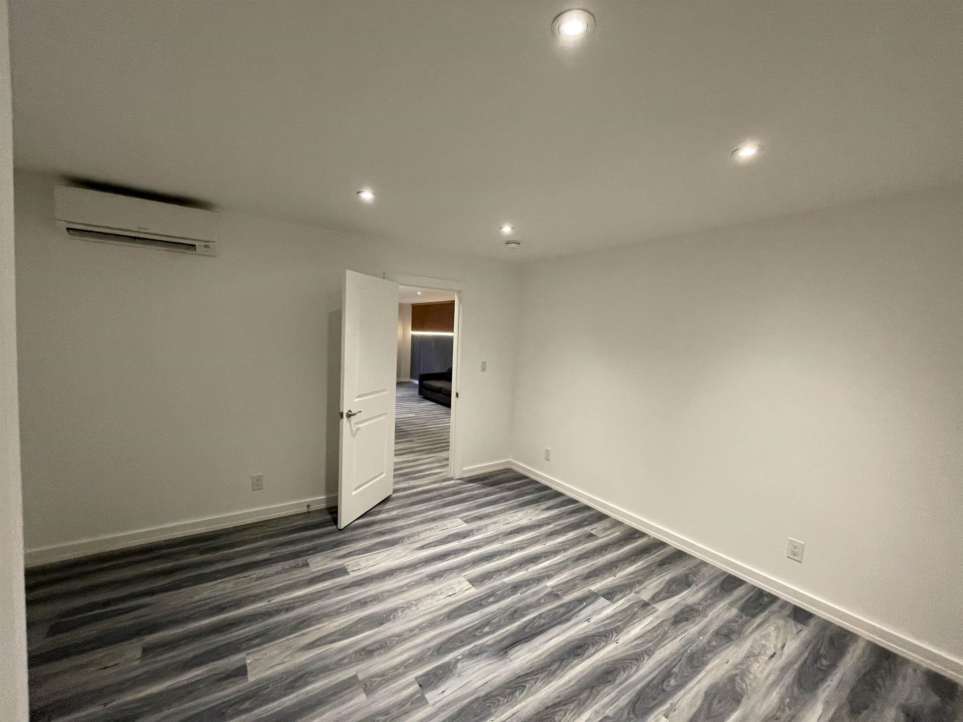 516 Paterson Plank Road, Unit 2R Jersey City, NJ 07307 - Photo 4 of 13 a view of a room with wooden floor and white walls