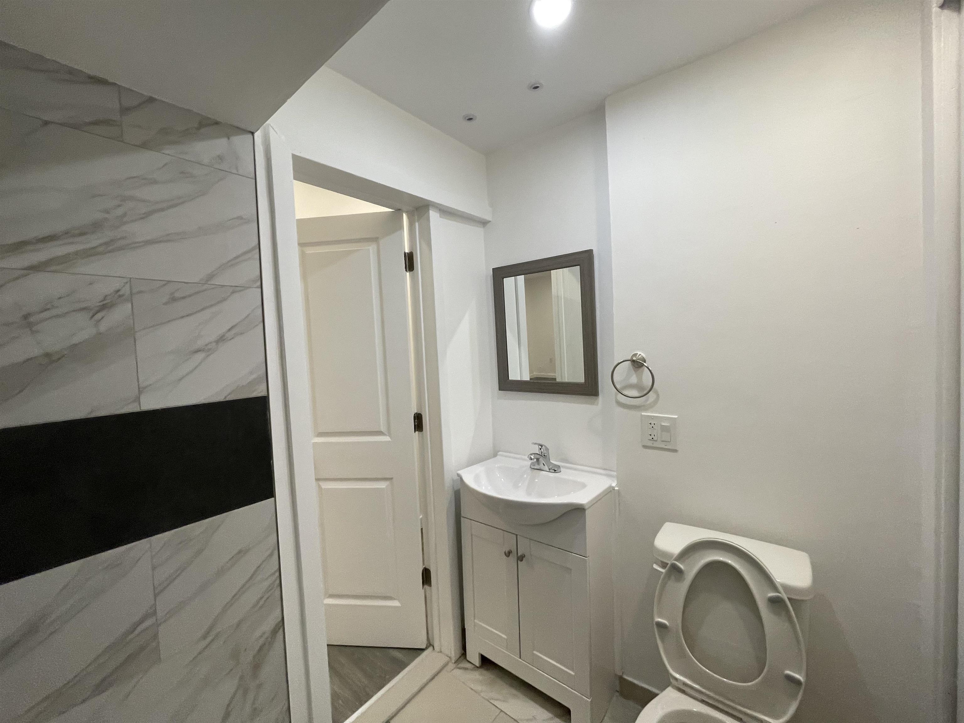 516 Paterson Plank Road, Unit 2R Jersey City, NJ 07307 - Photo 7 of 13 a bathroom with a sink and a mirror