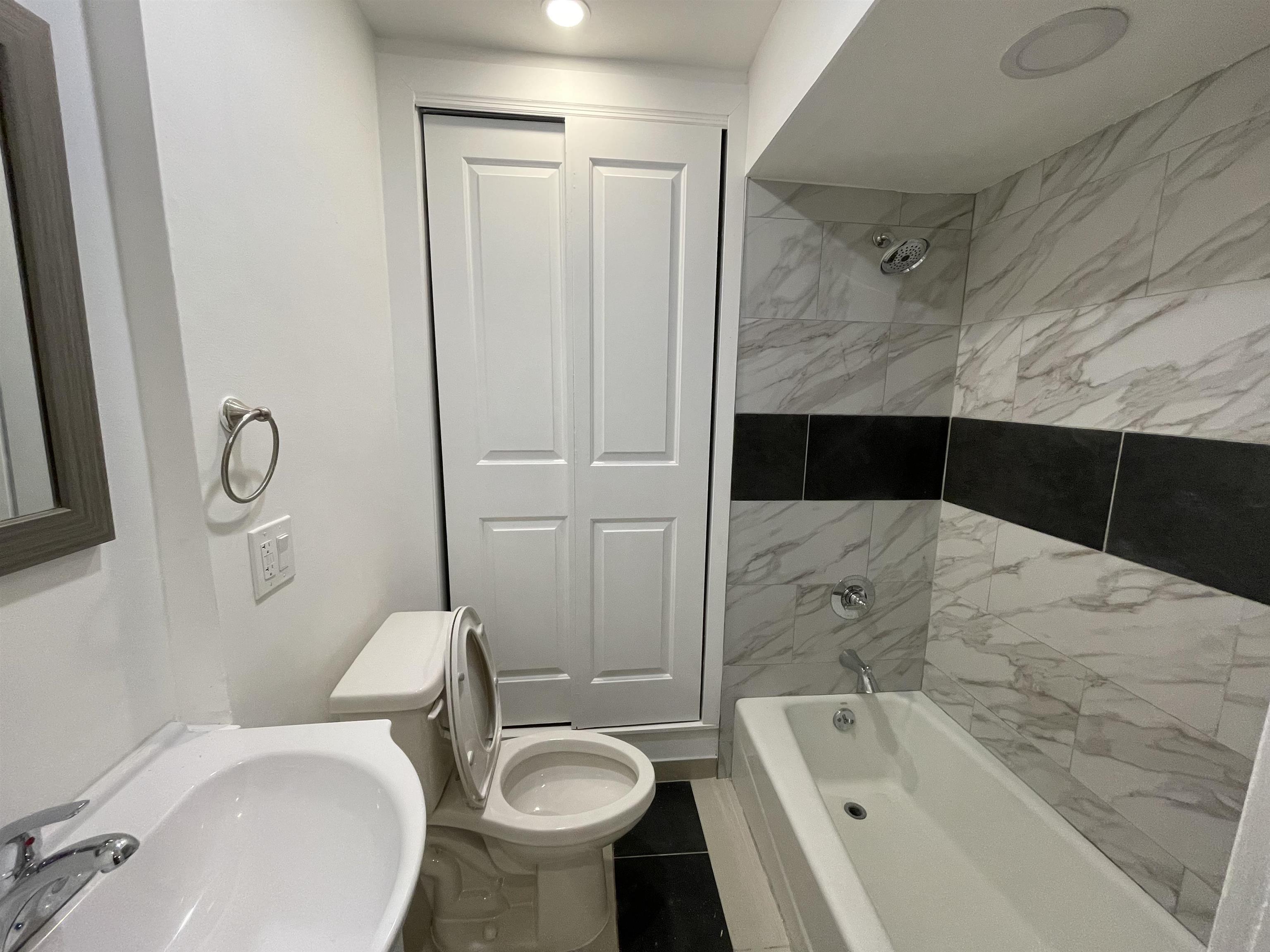 516 Paterson Plank Road, Unit 2R Jersey City, NJ 07307 - Photo 8 of 13 a bathroom with a sink toilet and shower