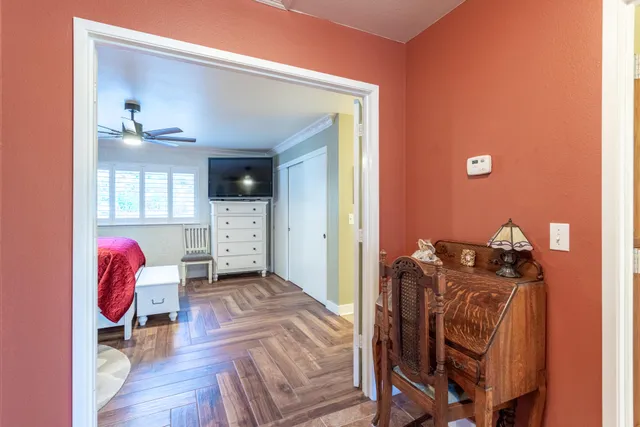 a living room with furniture and a mirror