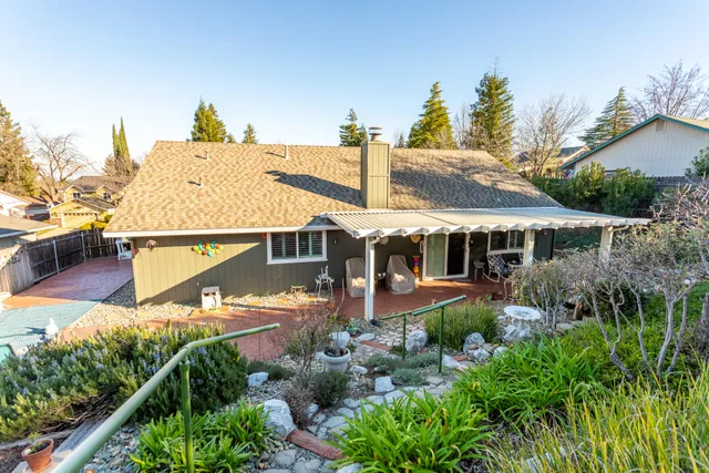 an aerial view of a house with swimming pool and garden
