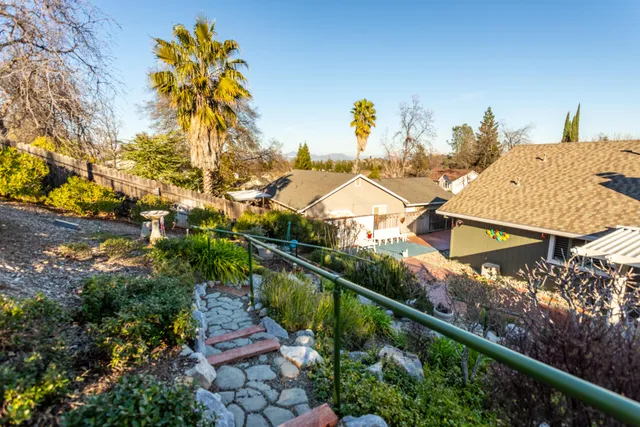 a view of a swimming pool with a patio and fire pit
