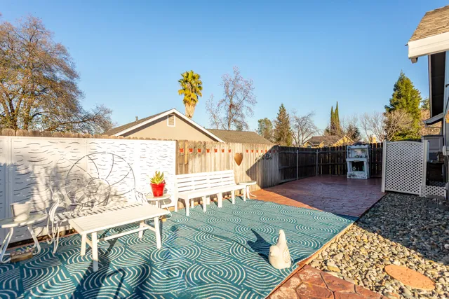 a view of a patio with couches table and chairs and potted plants