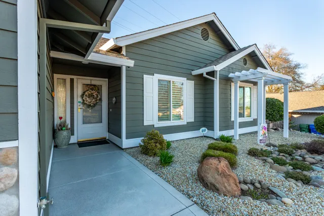 a front view of a house with garden