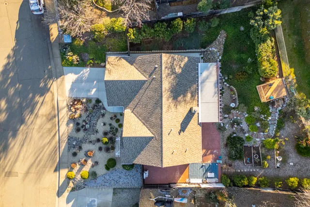 an aerial view of a house with a yard and garden