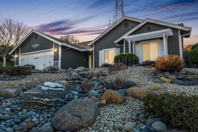 a front view of house with yard and outdoor seating