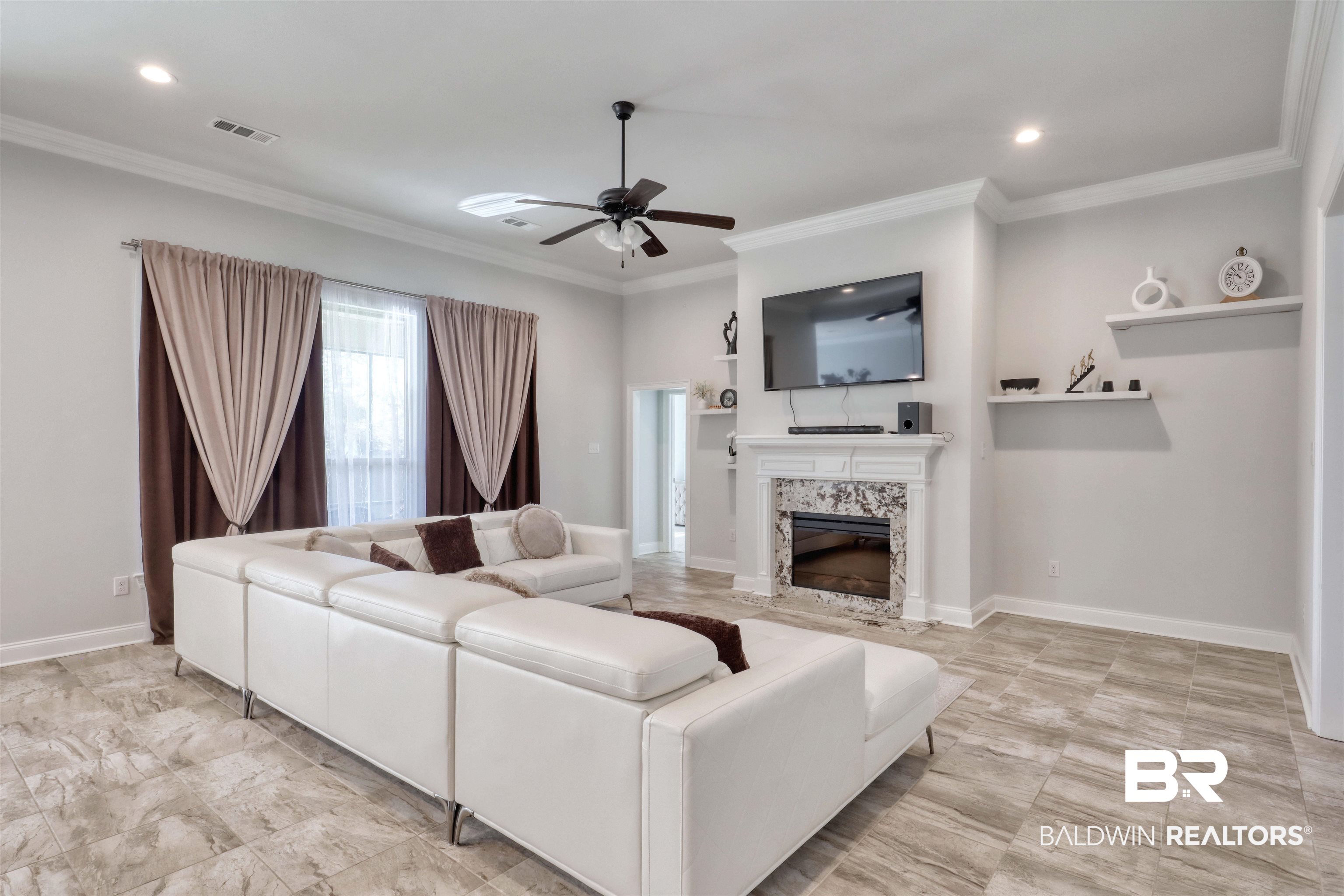 992 Dalton Circle Foley, AL 36535 - Photo 9 of 28 Living area featuring crown molding, a ceiling fan, a premium fireplace, and recessed lighting