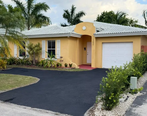 a front view of house and yard with swimming pool and outdoor seating