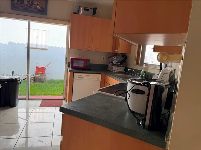a kitchen with a sink appliances and cabinets
