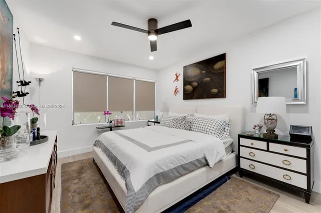 a spacious bedroom with a bed and a flat screen tv