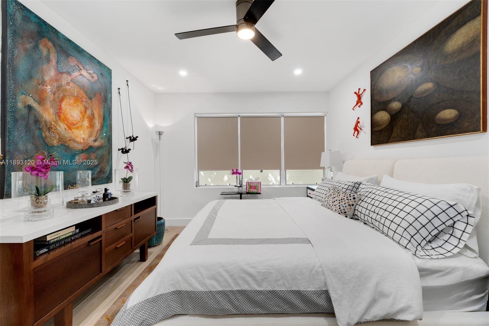 4720 Pine Tree Drive, Unit 2 Miami Beach, FL 33140 - Photo 12 of 23 a spacious bedroom with a bed and a large mirror