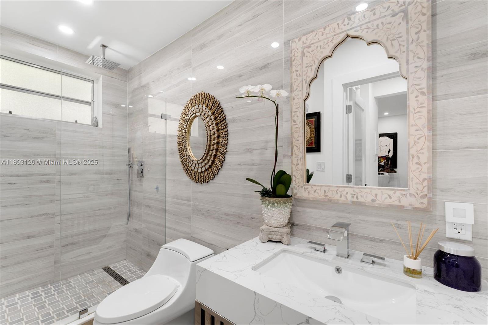 4720 Pine Tree Drive, Unit 2 Miami Beach, FL 33140 - Photo 14 of 23 a bathroom with a sink mirror and toilet