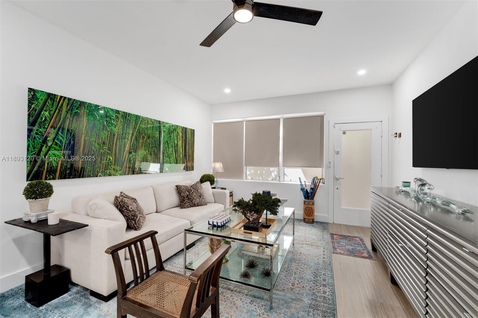 4720 Pine Tree Drive, Unit 2 Miami Beach, FL 33140 - Photo 2 of 23 a living room with furniture and a flat screen tv