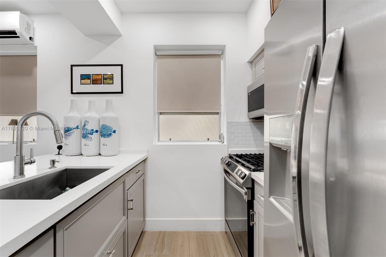 4720 Pine Tree Drive, Unit 2 Miami Beach, FL 33140 - Photo 10 of 23 a kitchen with a sink and a refrigerator
