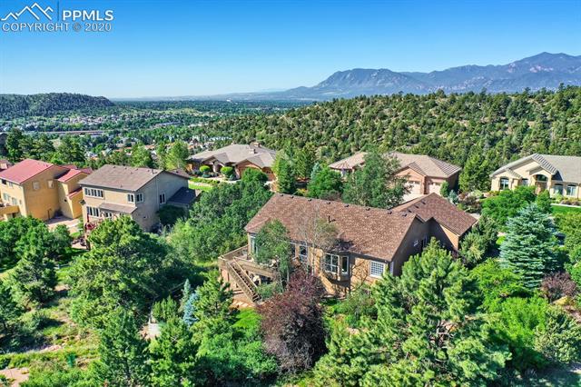4715 Seton Hall Road Colorado Springs, CO 80918 - Photo 4 of 4 Alternate aerial view of the rear elevation, Front Range, and the heavily treed lot