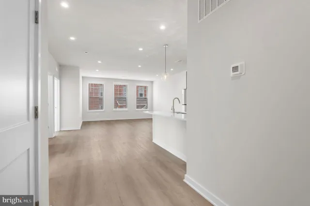 a kitchen with stainless steel appliances a refrigerator sink and microwave